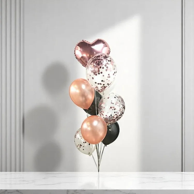 A set of metallic foil balloons in silver, gold, and rose gold colors with a mix of solid and dotted patterns, displayed against a neutral background.