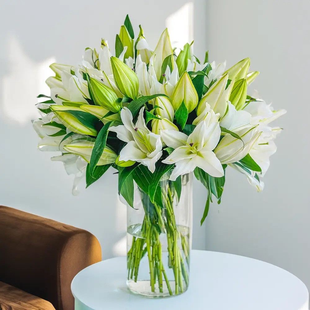 Elegant white lily bouquet in a glass vase by Buy Flower Box, flower delivery in Kuwait