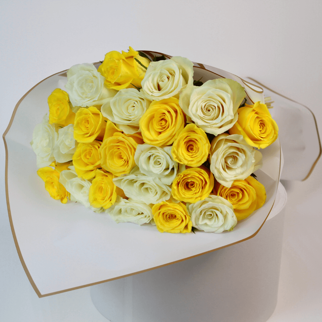 White and yellow rose flower bouquet with fresh roses arranged in elegant wrapping for flower delivery in Kuwait