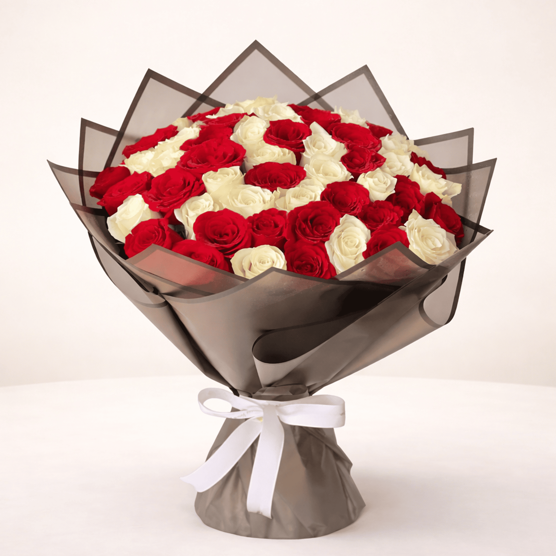 Hand-tied bouquet of 50 red and white roses for flower delivery in Kuwait