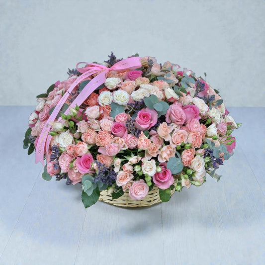 Luxury mixed rose flower basket with pink and peach roses arranged for flower delivery in Kuwait