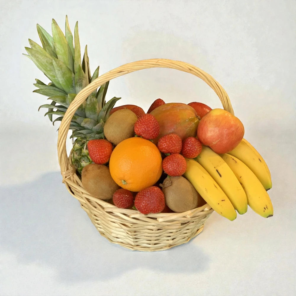 Fruit basket with pineapple, oranges, bananas, and strawberries on a light background