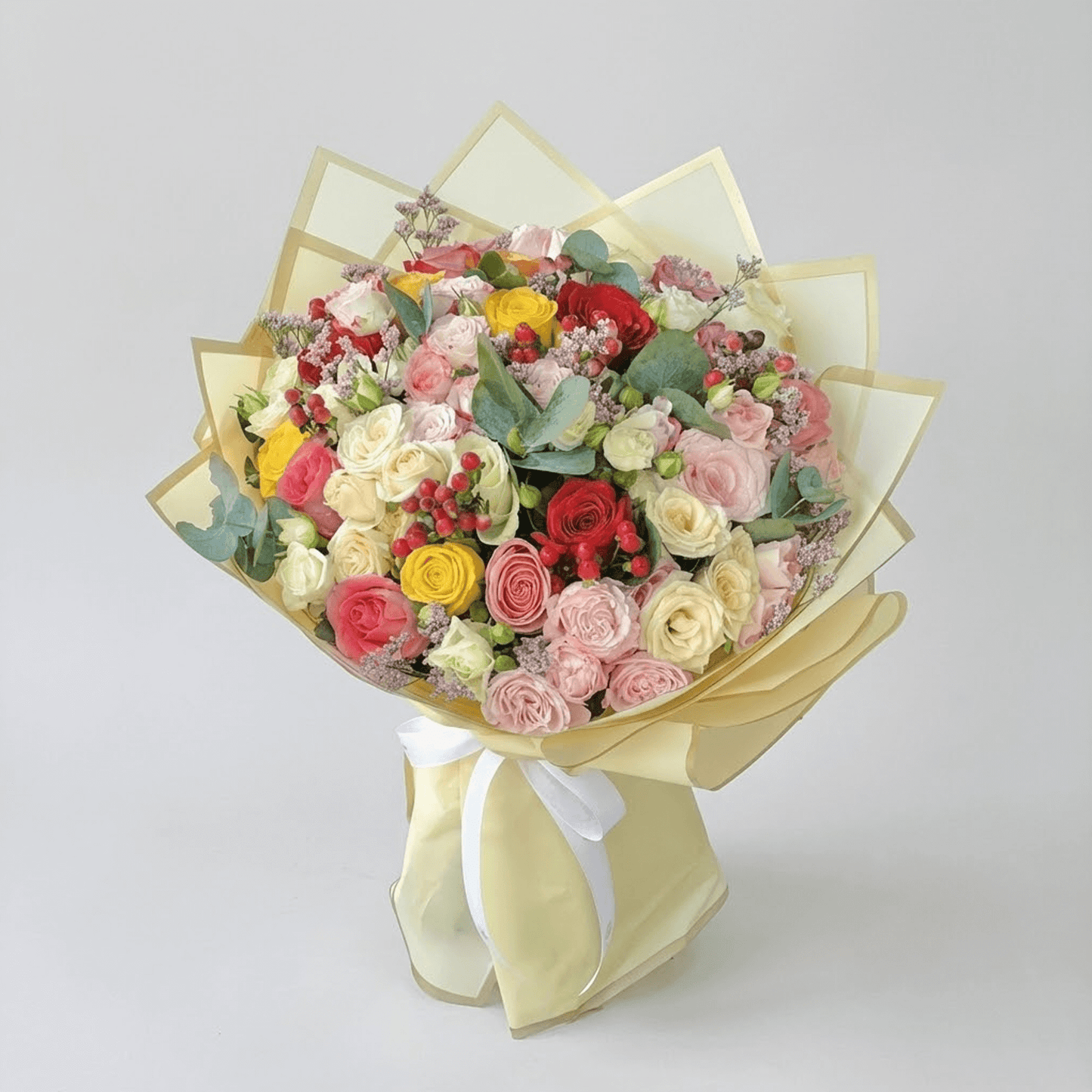 Mixed roses and spray roses flower bouquet with pastel and red blooms for flower delivery in Kuwait