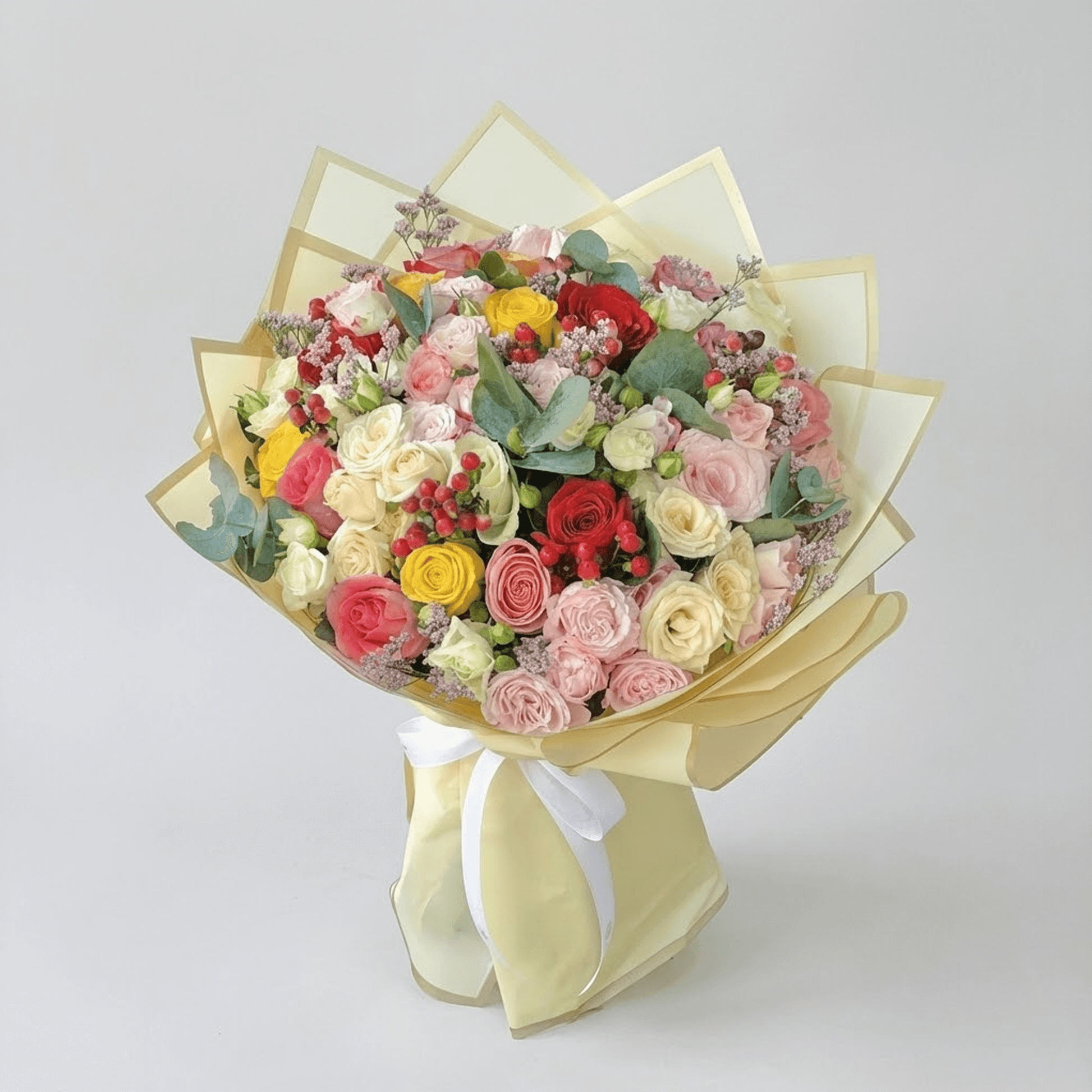 Mixed roses and spray roses flower bouquet with pastel and red blooms for flower delivery in Kuwait