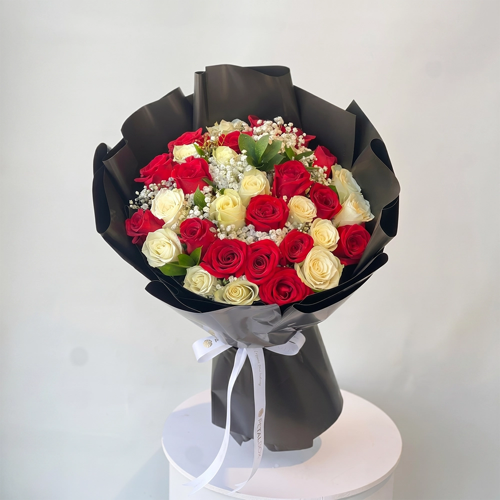 Ruby Pearl Rose Bouquet with fresh red and white roses in black wrapping for flower delivery Kuwait by Buy Flower Box.