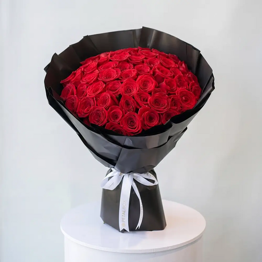 Scarlet Rose Bouquet with 50 fresh red roses wrapped in black paper for flower delivery Kuwait by Buy Flower Box.