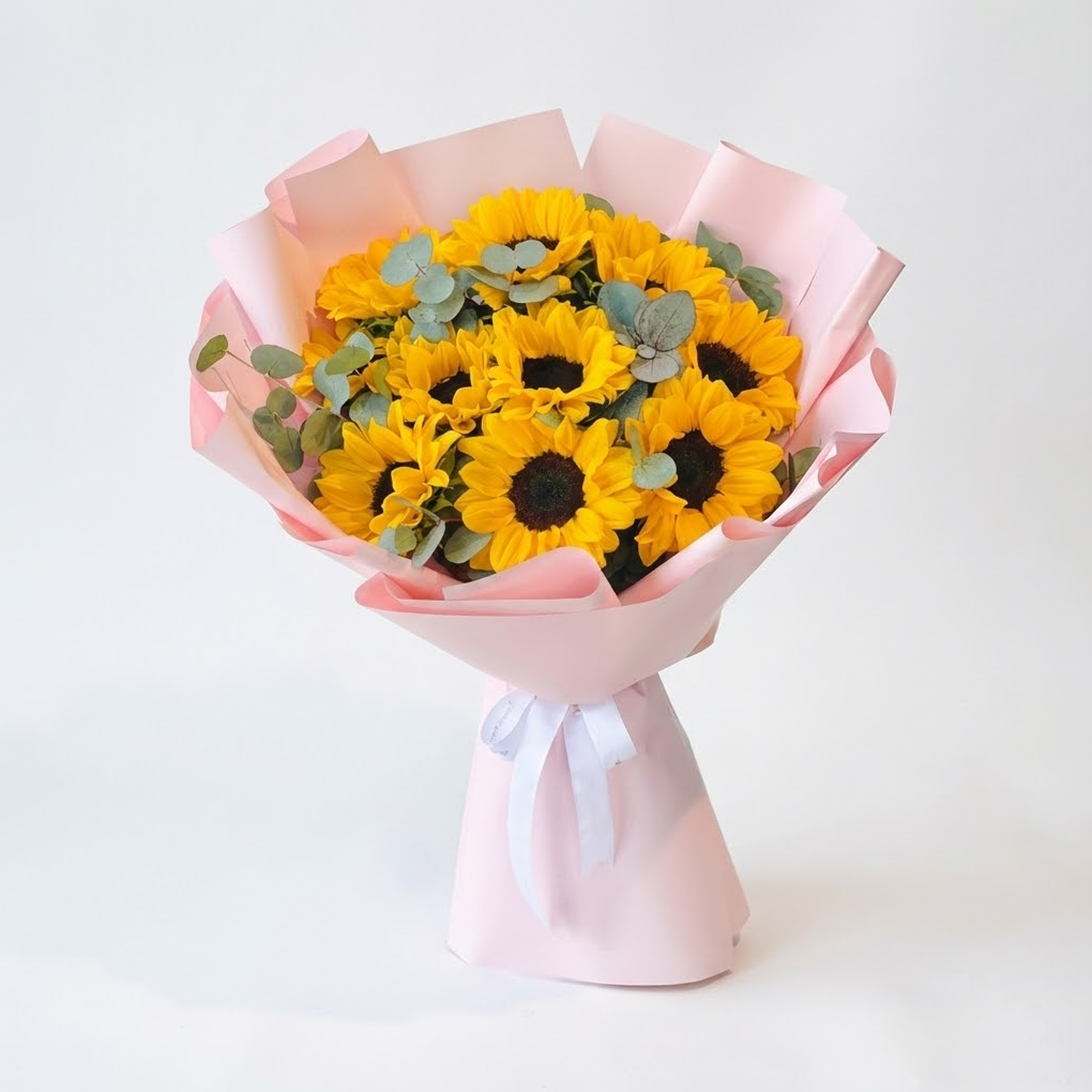 Sunflower bouquet wrapped in pink paper by Buy Flower Box, flower delivery in Kuwait
